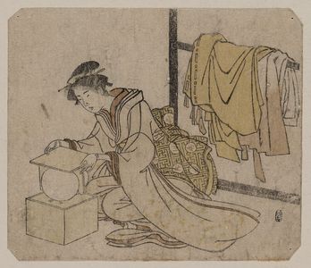 Unknown: Young lady removing a kemari (ball) from its box. - Library of Congress