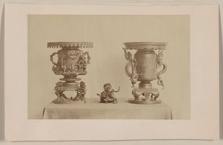 Unknown: [Tall, metal, ornate plant stands and figurine, all with dragon motif, on a table] - Library of Congress